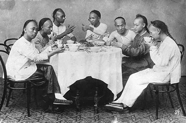 Chinese men around a banquet table