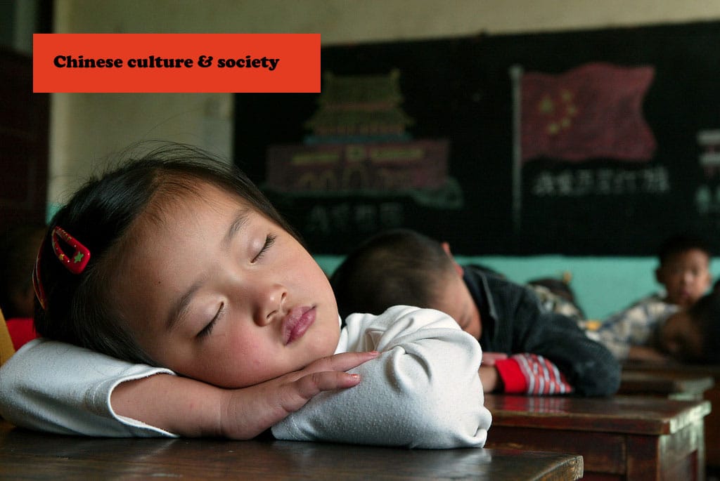 A Chinese student sleeps on her desk