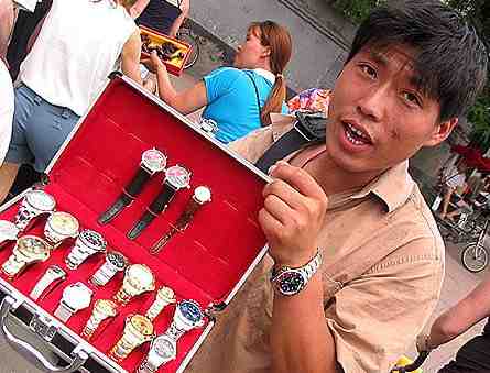 Chinese man holds a set of silverware to try to sell