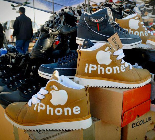 Pile of shoes with Apple "iPhone" branded shoes zoomed in