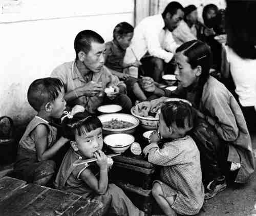 Chinese family eating a meal together