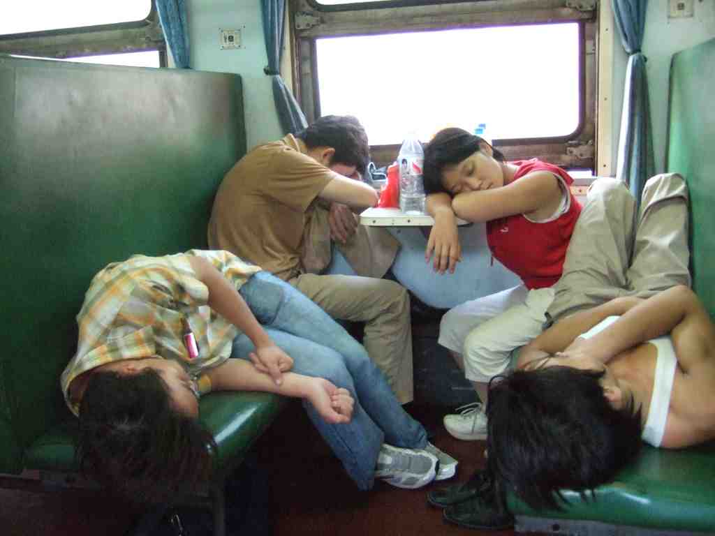 hard seat train small A Chinese family sleeping on hard seats on the bullet train