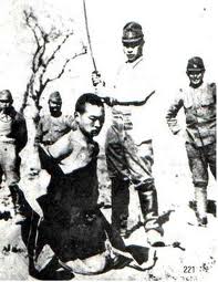 A Japanese soldier in position to behead a Chinese man